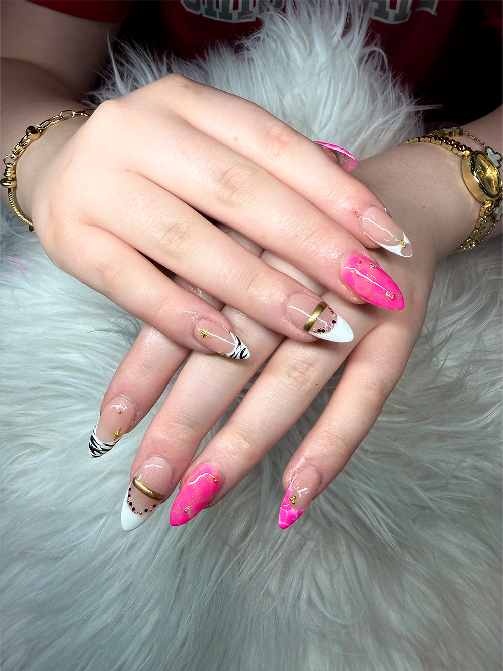 Hot pink almond nails with white French tips, zebra stripes, gold accents and rhinestones by Chic Nail and Head Spa